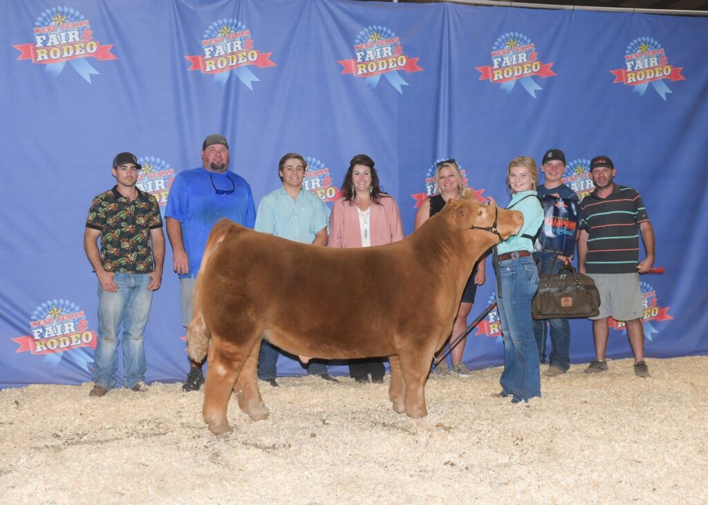 Kendyl Rust stands in show circle with winning steer