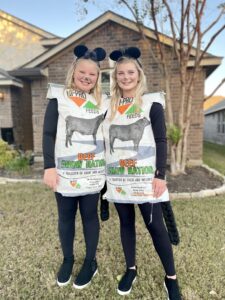 Kendyl and Taygan wear show feed bags and cow ears and tails